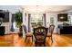 Dining area features a modern chandelier, hardwood floors and natural light, complemented by dark cabinets at 1045 Paper Creek Dr, Lawrenceville, GA 30046