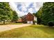Beautiful brick home with a spacious front yard and a long driveway leading to a two-car garage at 1045 Paper Creek Dr, Lawrenceville, GA 30046