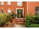 Elegant brick entryway with decorative lion statues and lush landscaping at 1045 Paper Creek Dr, Lawrenceville, GA 30046