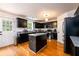Modern kitchen featuring black cabinetry, stainless steel appliances, granite countertops, and a functional center island at 1045 Paper Creek Dr, Lawrenceville, GA 30046