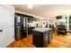 The kitchen featuring black cabinetry, stainless steel appliances, and granite countertops that opens to the dining area at 1045 Paper Creek Dr, Lawrenceville, GA 30046