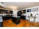 Bright kitchen featuring dark cabinets, stainless appliances, granite countertops and a functional center island on hardwood floors at 1045 Paper Creek Dr, Lawrenceville, GA 30046