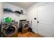 A functional laundry room is equipped with modern washer and dryer, complemented with laminate flooring at 1045 Paper Creek Dr, Lawrenceville, GA 30046