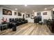 Living room area with a row of theater chairs and wood flooring at 1045 Paper Creek Dr, Lawrenceville, GA 30046