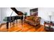 Elegant living room with a grand piano, sofa, and hardwood floors at 1045 Paper Creek Dr, Lawrenceville, GA 30046
