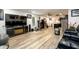 Spacious living room area with entertainment system, wood floors and kitchen access at 1045 Paper Creek Dr, Lawrenceville, GA 30046