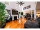 Bright living room has a fireplace and an open layout, connecting to the kitchen and dining area on hardwood floors at 1045 Paper Creek Dr, Lawrenceville, GA 30046