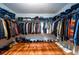 Walk-in closet with shelves for storage and wood floors at 1045 Paper Creek Dr, Lawrenceville, GA 30046