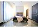A bright bedroom features polished concrete floors, neutral decor, and a comfortable bed with stylish bedding at 1195 Milton Se Ter # 1109, Atlanta, GA 30315