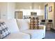 Living room with kitchen view with stainless steel appliances, white cabinetry and granite countertops at 1195 Milton Se Ter # 1109, Atlanta, GA 30315