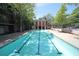 Community swimming pool featuring a long pool, lounge chairs, and lush greenery at 1195 Milton Se Ter # 1109, Atlanta, GA 30315