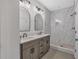 Elegant bathroom with double vanity, marble countertop, modern faucets and glass-enclosed shower with pebble floor at 135 Old Alabama Rd, Emerson, GA 30137