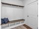Mudroom features a dark stained bench, storage cubbies, shiplap detail, and wood flooring at 135 Old Alabama Rd, Emerson, GA 30137