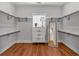 Bright walk-in closet features custom shelving, wood floors, window, and ample storage space at 135 Old Alabama Rd, Emerson, GA 30137