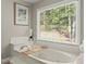Bathroom featuring a luxurious soaking tub and a large window at 4223 N Mountain Ne Rd, Marietta, GA 30066
