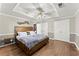 Spacious bedroom features hardwood floors, a tray ceiling with fan, and a large bed at 4223 N Mountain Ne Rd, Marietta, GA 30066