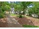 Traditional two story home with a manicured front lawn, mature trees, and a private drive in a serene setting at 4223 N Mountain Ne Rd, Marietta, GA 30066