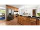 Well-lit kitchen with wood cabinets, stainless refrigerator, and adjacent eat-in area at 4223 N Mountain Ne Rd, Marietta, GA 30066