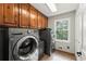 Functional laundry room with modern washer, dryer, storage cabinets, and natural light at 4223 N Mountain Ne Rd, Marietta, GA 30066
