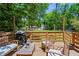 Inviting back deck with outdoor seating, a grill, and a view of a green, leafy yard at 1790 Shirley Sw St, Atlanta, GA 30310