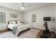 Bright bedroom featuring hardwood floors, ceiling fan, and large windows at 1790 Shirley Sw St, Atlanta, GA 30310