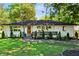 Charming single-story home featuring a white brick exterior, manicured lawn and well-maintained landscaping at 1790 Shirley Sw St, Atlanta, GA 30310
