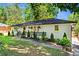 Single-story home showcasing a well-manicured lawn, white-painted brick, and tastefully landscaped front yard at 1790 Shirley Sw St, Atlanta, GA 30310