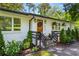 Close up of exterior featuring a wood door, white painted brick, and manicured front yard landscaping at 1790 Shirley Sw St, Atlanta, GA 30310