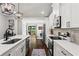 Bright kitchen features stainless steel appliances, white cabinets, an island, and hardwood floors at 1790 Shirley Sw St, Atlanta, GA 30310