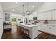 Spacious kitchen with a large island, white cabinets, stainless steel appliances, and modern pendant lights at 1790 Shirley Sw St, Atlanta, GA 30310