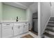 Modern kitchenette with white cabinets, quartz countertops, and stainless steel refrigerator at 1790 Shirley Sw St, Atlanta, GA 30310