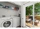 Well-equipped laundry room with washer, dryer, storage and access to the backyard deck at 1790 Shirley Sw St, Atlanta, GA 30310
