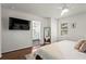 Bright bedroom features wood floors and a view to an ensuite bathroom at 1790 Shirley Sw St, Atlanta, GA 30310