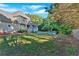 Spacious backyard with a lush lawn, a screened porch, and an inviting in-ground swimming pool at 185 Waverly Walk, Douglasville, GA 30134