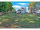 Expansive backyard featuring a lush lawn, mature trees, and a classic home with a screened porch at 185 Waverly Walk, Douglasville, GA 30134