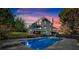 Beautiful backyard featuring a pool, spacious patio, and lush greenery at 185 Waverly Walk, Douglasville, GA 30134