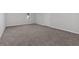 Bedroom features neutral carpet, a large window, and a door at 185 Waverly Walk, Douglasville, GA 30134