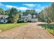 Two-story home featuring a covered front porch, attached garage, long driveway and large front lawn at 185 Waverly Walk, Douglasville, GA 30134