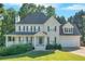 Two-story home featuring a covered front porch, attached garage, well-manicured lawn and mature shade trees at 185 Waverly Walk, Douglasville, GA 30134