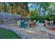 Cozy firepit area with colorful Adirondack chairs surrounded by a gravel patio and tasteful landscaping at 185 Waverly Walk, Douglasville, GA 30134