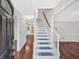 Bright foyer with white staircase, hardwood floors, chandelier and open floor plan at 185 Waverly Walk, Douglasville, GA 30134