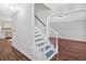 Bright foyer featuring a staircase, hardwood floors, and neutral paint at 185 Waverly Walk, Douglasville, GA 30134