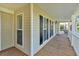 Covered front porch featuring wood flooring, white railings and traditional design elements at 185 Waverly Walk, Douglasville, GA 30134