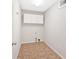 Bright laundry room with white cabinets, tile flooring and utility connections at 185 Waverly Walk, Douglasville, GA 30134