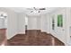 Bright, airy living room features hardwood floors, a ceiling fan, and white trim at 185 Waverly Walk, Douglasville, GA 30134