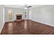 Bright living room featuring a brick fireplace, hardwood floors, and ample natural light from large windows at 185 Waverly Walk, Douglasville, GA 30134