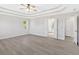 Spacious main bedroom with tray ceiling and ceiling fan boasts natural light and access to a doorway at 185 Waverly Walk, Douglasville, GA 30134