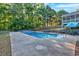 Backyard pool with concrete surround and sun loungers at 185 Waverly Walk, Douglasville, GA 30134