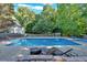 Inviting in-ground pool area with comfortable lounge chairs and a peaceful setting for relaxation at 185 Waverly Walk, Douglasville, GA 30134