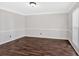 Room features updated hardwood floors, large window for natural light, and chair rail at 185 Waverly Walk, Douglasville, GA 30134